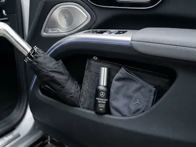 Premium umbrella and hygiene kit provided for passenger safety and comfort in a Mercedes EQS