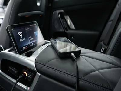 Inside a BMW 7 Series showing high-speed Wi-Fi and USB charging for passengers.