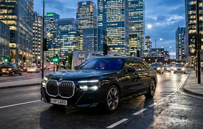 Business professionals using a BMW i7 Chauffeur Service for corporate events.