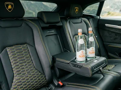Complimentary refreshments including energy drinks and water in the back of a Lamborghini Urus.