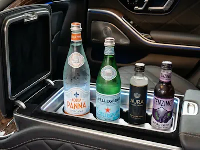 Premium refreshments including still, sparkling water, and energy drinks in a Mercedes S-Class Chauffeur Service.