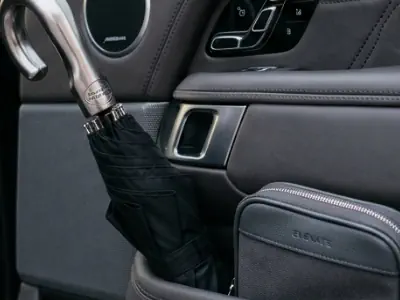 Premium umbrella and hygiene kit provided for guests in a Range Rover chauffeur service.