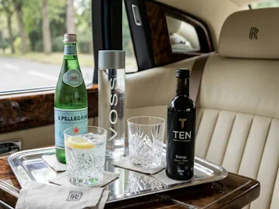 Complimentary sparkling water and drinks served during your Rolls-Royce Phantom chauffeur service.